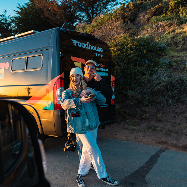 A couple traveling in a Roadhouse camper van